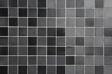tiled background with square tiles in different shades of black and gray