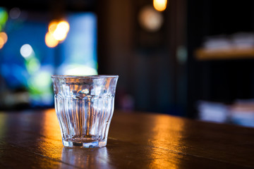 Mineral water in glass bottle left on the wooden table, concept of healthy food and drink.