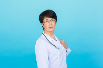 Portrait of doctor woman with stethoscope over blue background