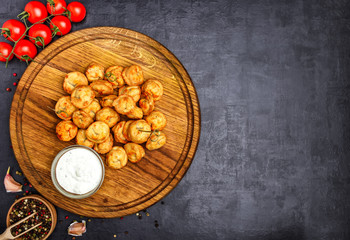 Dumplings stuffed with meat sprinkled with fresh herbs , top view, black background