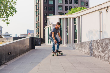 Fototapeta premium Young man riding a skateboard on the street.