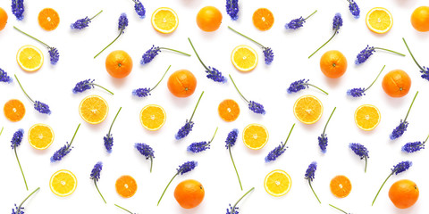 Seamless pattern of fresh oranges and blue flowers isolated on white background, top view, flat lay. Food texture background. Healthy food, detox, diet, summer concept.