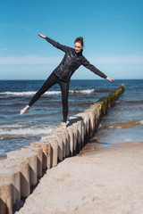 Happy carefree young woman balancing