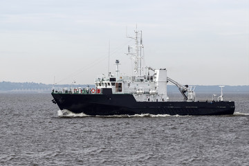 Fototapeta na wymiar Tugboat on the open sea