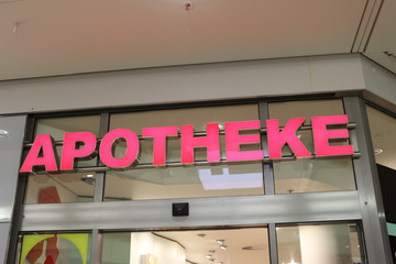 Apotheke signage, pharmacy store sign in German language outside a store