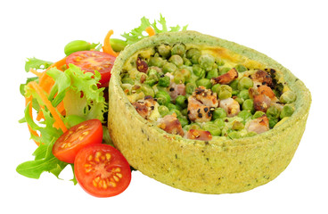Pea and pancetta filled savoury quiche with fresh simple salad isolated on a white background