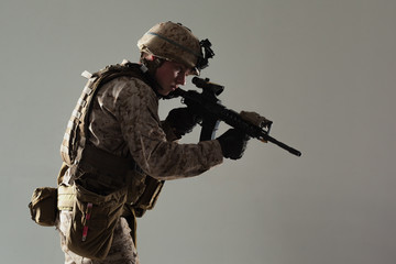 Soldier in camouflage holding rifle
