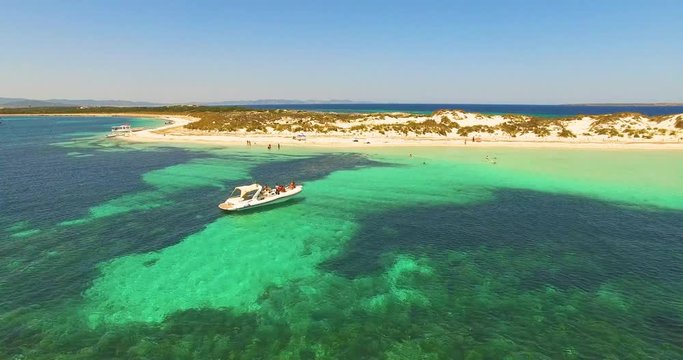 Aerial view of Yatch with friends in amazing, unspoiled and idyllic beach on a little island