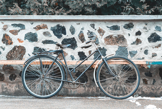Vintage bicycle on the stone wall background