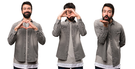 Set of Handsome man with beard making a heart with his hands and sending a kiss