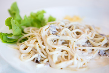 Kids are eating delicious spaghetti.