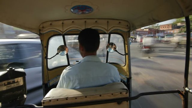 Rickshaw drivie through the Traffic congestion and street life in the City of Jaipur, Rajasthan, India