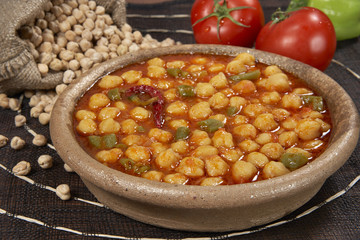 chickpeas in tomato sauce in bowl closeup. horizontal
