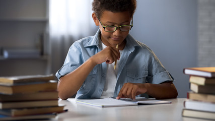 Boy with disability to learn reading and writing skills trying to concentrate