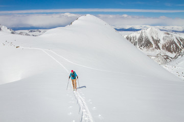 Fototapeta na wymiar A skier walks in the mountains