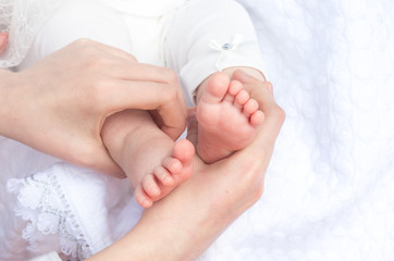 legs little newborn baby sister in the hands