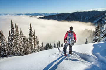 A skier walks in the mountains