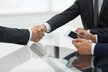 Two confident businessmen shaking hands during a meeting in the 