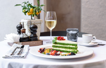 Large white dish, cheesecake with fresh berries. Bright bokeh background.