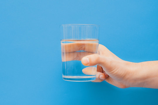 Drinking water concept one hand holding glass