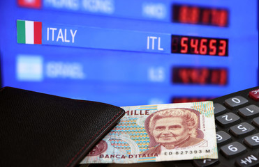 One thousand Lire of Italy banknote with black wallet on the calculator with digital board of currency exchange money background, Lire Italia money the concept of finance.