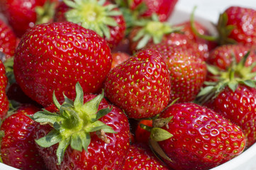 Strawberries in bowl, detail view.