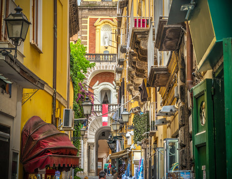 Fototapeta Narrow alley with Duomo steeple on the background in Sorrento