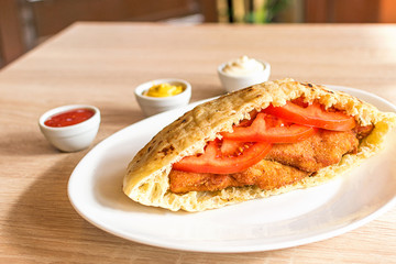 Delicious crispy chicken in pita bread with fresh salad ingredients