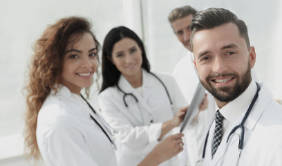 Fototapeta premium Portrait of aged male doctor teaching medical students.