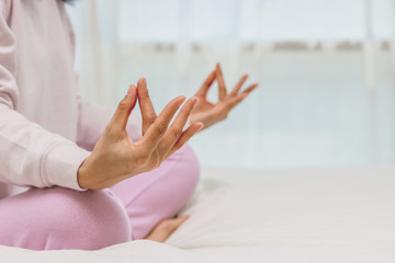 Obraz na płótnie Canvas Asian women play yoga on bed in morning