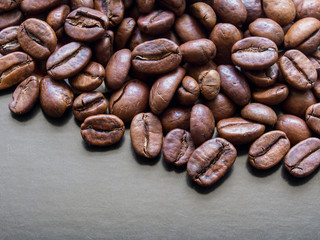 Roasted coffee beans macro on dark grey background with copy space
