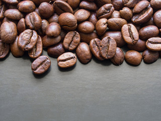 Roasted coffee beans macro on dark grey background with copy space