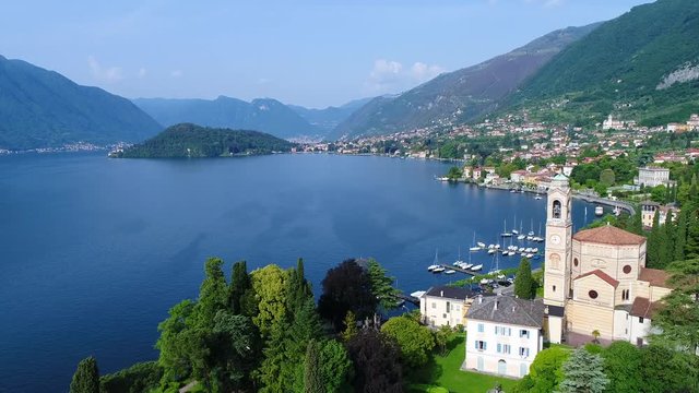 Village of Tremezzo, church of San Lorenzo. Lake of Como in Italy, important touristic destination. Aerial view with drone.