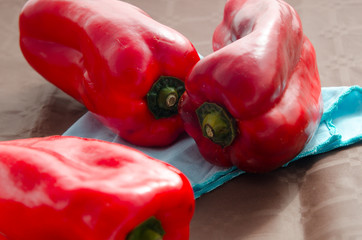 red peppers, on table with brown tablecloth