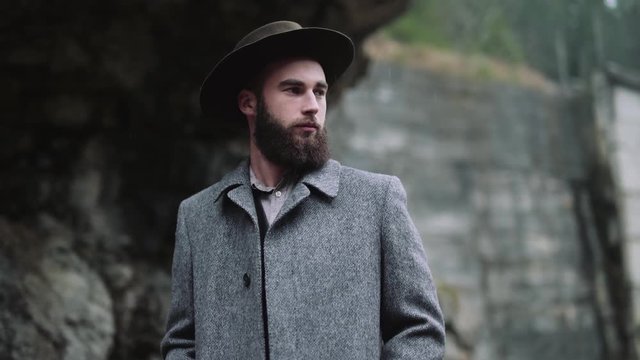 stylish hipster man in hat. rustic fashionable look in Mountains and forest.