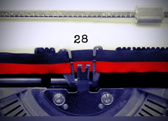 28 Number by the old typewriter on white paper