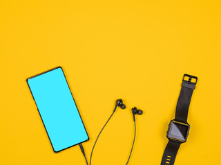 Flat lay top view of smartphone and smartwatch. Design and concept. Orange background