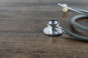 Stethoscope on wooden table background. medical health concept.