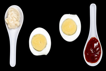  boiled egg with spoons with mayonnaise and ketchup