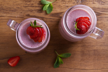 Milkshake with strawberries and banana. Strawberry smoothie. View from above, top studio shot