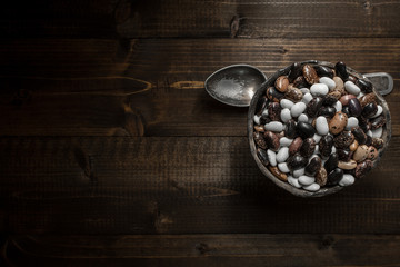 Raw Colorful Beans on Dark Wooden Background