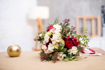 beautiful modern wedding bouquet on the table. Against the gray wall