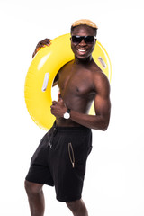 Portrait of a happy cheerful afro american man in summer shorts holding inflatable ring and...
