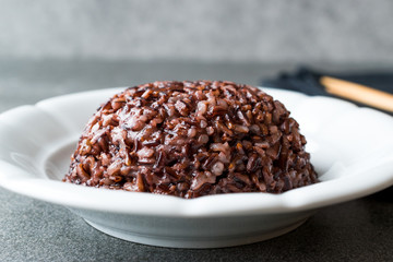 Cooked Black Rice in white Plate with Chopsticks.