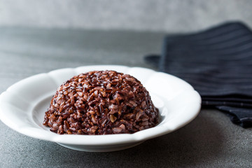 Cooked Black Rice in white Plate with Chopsticks.