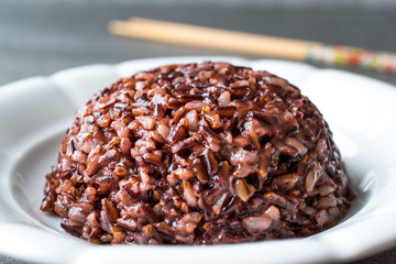 Cooked Black Rice in white Plate with Chopsticks.