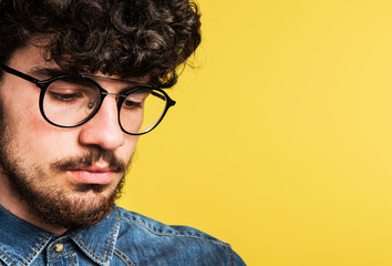 Portrait of a young man in a studio. Copy space.