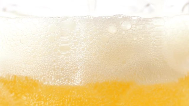 Close up of pouring beer with bubbles. No sound.
