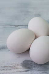 White eggs on a wooden background