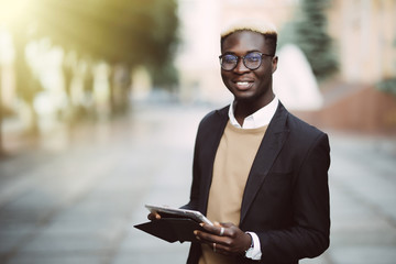 African businessman working with tablet outdoor. Black people - Concept about people, business, lifestyle and technology